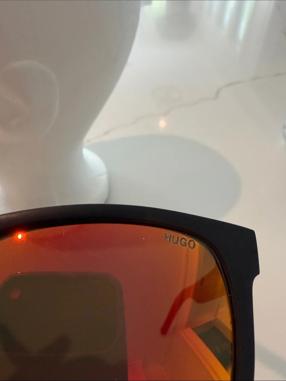 HUGO Men’s Black Sunglasses (recycled nylon) with Red-Orange Mirrored Lenses.
